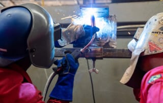 Student gets supervised instruction in paid welder training program at The Systems Group