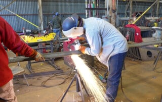 Student at work in welding job with training